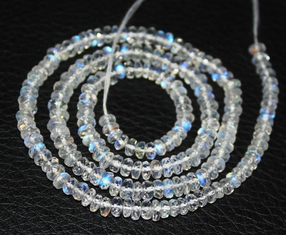 Two 13-inch strands of blue fire natural rainbow moonstone faceted rondelle beads, sized 4-4.5mm. These gemstones showcase a vibrant blue shimmer, ideal for adding a mystical touch to custom necklaces or bracelets in handmade jewelry designs