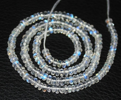Two 13-inch strands of blue fire natural rainbow moonstone faceted rondelle beads, sized 4-4.5mm. These gemstones showcase a vibrant blue shimmer, ideal for adding a mystical touch to custom necklaces or bracelets in handmade jewelry designs